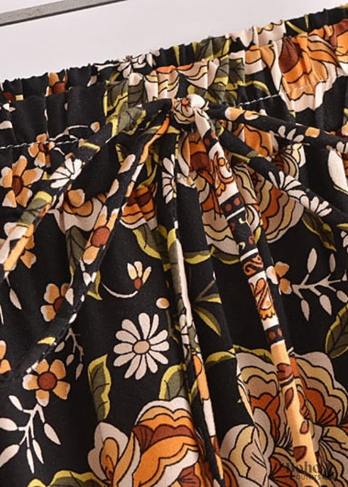 Faldas bohemias con estampado Maryam de flores negras y doradas para mujer